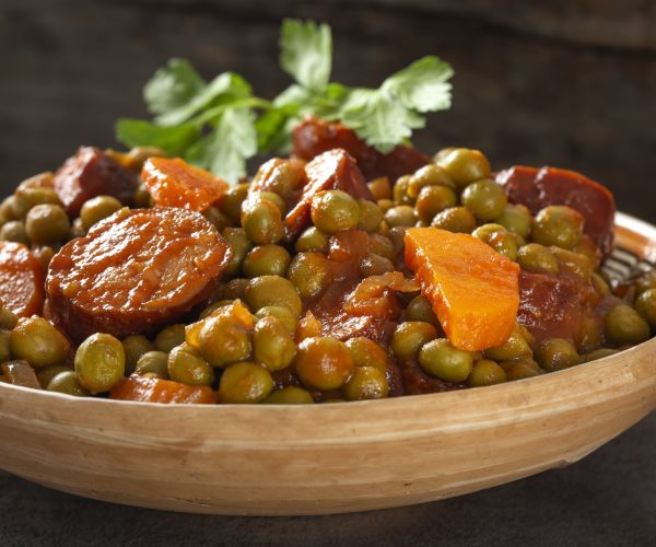 Peas stew with carrot and pork sausages